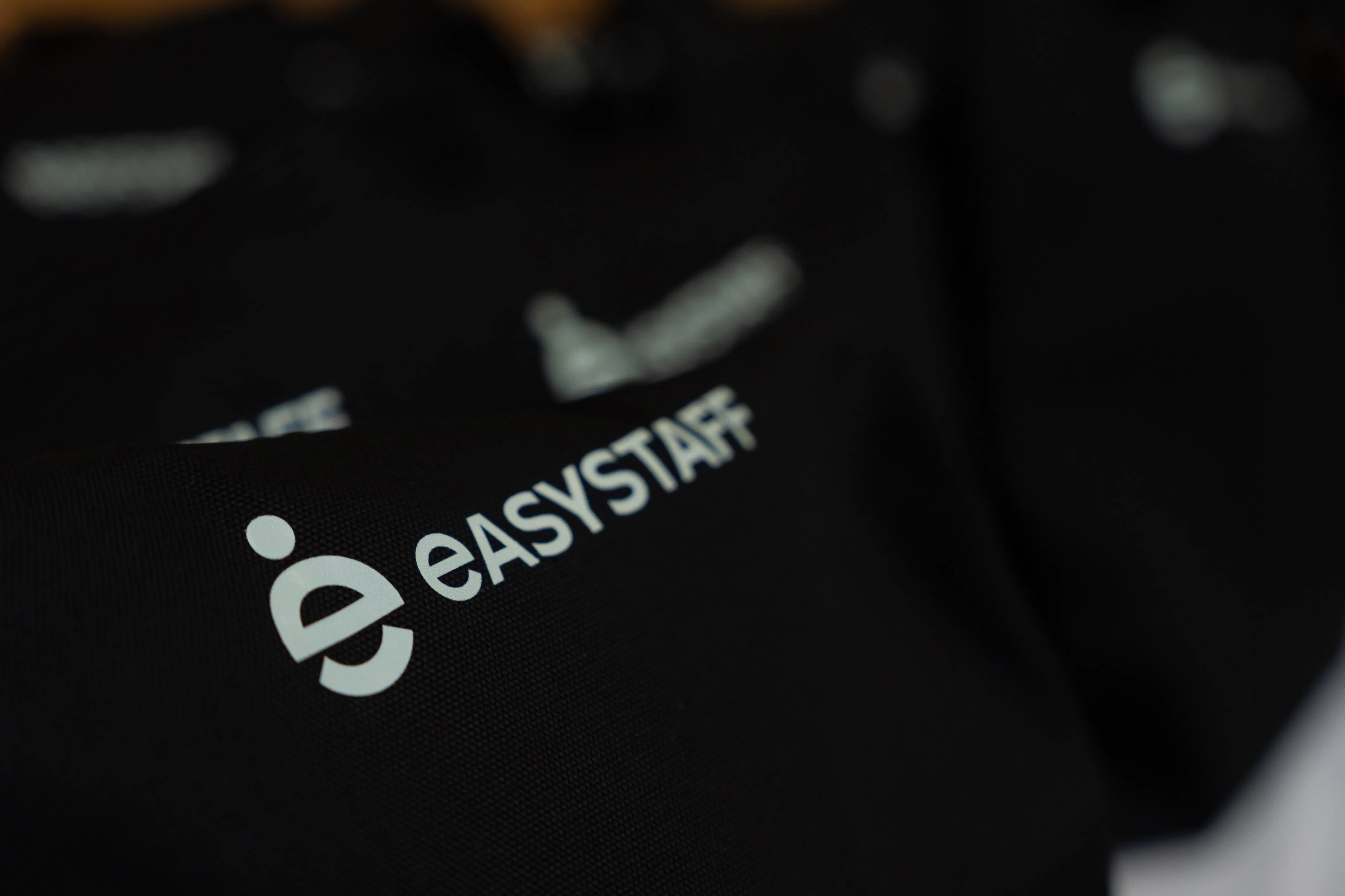 EasyStaff branding on black fabric